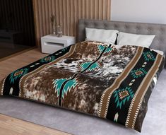 a bed covered in a brown and blue blanket