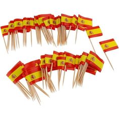 many small flags are on sticks with toothpicks in the shape of spain's flag