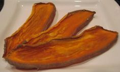 two pieces of sweet potato sitting on top of a white plate