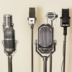 several microphones are lined up against a wall