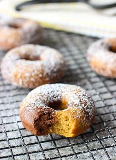 some sugared donuts are on a cooling rack