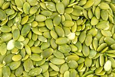 a pile of pistachio beans is shown in close up view with no image to describe