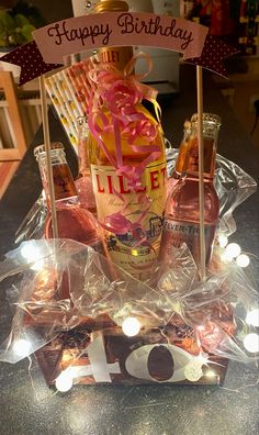 a birthday cake made to look like a bottle of booze and some candies