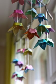 colorful origami birds hanging from the ceiling