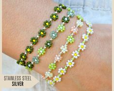 the bracelets are made with glass beads and flowers on each side of the arm