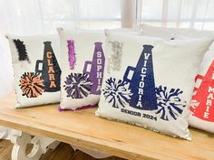 three decorative pillows are sitting on a table