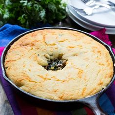 a pie sitting in a pan on top of a table next to plates and utensils