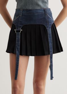 The identity of Andersson Bell was inspired by the merge of two contrasting cultures, reinterpreting Scandinavian aesthetic to create garments from a Korean perspective. Crafted from a wool and cotton blend, the Trompe L'oeil Mini Pleats Skirt features a non-stretch denim garter-style overlay. Cut to a mini length, it is detailed with a silver-toned D-ring on the straps and a leather logo patch at the back waistband.  - Wool-cotton blend fabric- Mini length- Garter-style denim layer- Knife pleats- Belt loops- Zip closure on the side- Leather logo patch at back waistband Materials:Main: 58% Wool, 42% Cotton. Denim: 100% Cotton. Care:Dry clean only. Sizing: Item fits true to size. Model wears a size 36 and is 176cm/5'9.5". Garters Aesthetic, Denim Belts, Pleats Skirt, Scandinavian Aesthetic, Knife Pleats, Denim Belt, Leather Logo, Skirts For Sale, D Ring