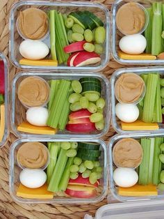 several plastic containers filled with different types of vegetables and dips on top of each other