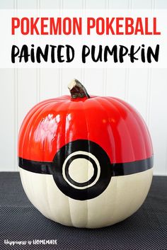 a pokemon poke ball painted pumpkin sitting on top of a black surface with text overlay