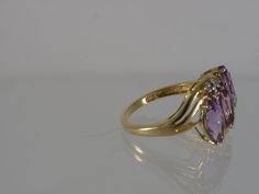 This beautiful vintage 1990's 3 stone ring is constructed of solid 14k yellow gold. The 3 natural Amethysts are cut into large Marquise and accented with 6 natural Diamonds. This ring ships in a brand new ring box. RING SIZE: 7.25 US (Sizable by your local jeweler) Metal: 14k yellow gold (Stamped 14K and verified by acid test) Gemstones: 3 Marquise Cut Amethyst aprx 10mm x 5mm and 6 Small Round Cut Accent Diamonds 1.5mm Weight: 3.9 grams MEASUREMENTS: from north to south: 14.5mm shank: 1.5mm sit Gold Three-stone Amethyst Ring For Anniversary, Classic Three Stone Amethyst Ring For Formal Occasions, Yellow Gold Three Stone Amethyst Ring, Three Stone Amethyst Ring In Yellow Gold, Anniversary Yellow Gold Three-stone Amethyst Ring, Gig Harbor Wa, 3 Stone Ring, Gig Harbor, Box Ring