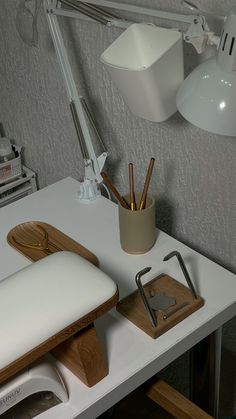 a desk with a lamp, mouse pad and other office supplies on top of it