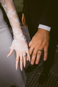 the bride and groom are holding hands together