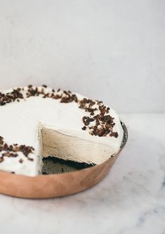 a cake with white frosting and chocolate sprinkles