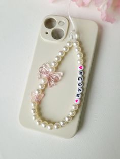 a cell phone case with pearls and a butterfly on it