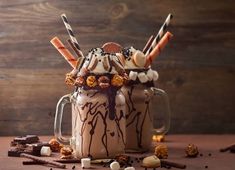 a mug filled with chocolate and marshmallows on top of a table