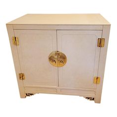 a white and gold cabinet with two doors