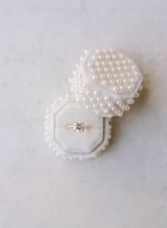 two pearls and a ring on top of each other