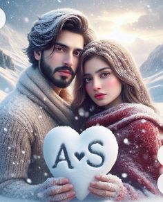 a man and woman holding a heart in the snow