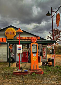 an old fashioned gas station in the middle of nowhere