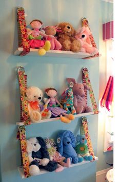 three shelves filled with stuffed animals on top of each other in a child's room