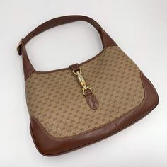 Please add your phone number on your order to avoid delays.Please keep in mind that all sales are final so please know that and ask all your questions before purchasing this. delays.100% Authentic Vintage Gucci monogram Jackie Shoulder Bag- Material: PVC canvas, leather - Hardware: Gold toned of hardware turned to silver- Color: Brown , Beige - The label logo inside reads “GUCCI MADE IN ITALY”- Inside: Removed all the peelings and left the soft cotton material underneath- Outside: some signs of Vintage Designer Bags, White Shoulder Bag, Gucci Vintage, Gucci Monogram, Leather Hardware, Vintage Purse, Brown Beige, Canvas Leather, Hobo Bag