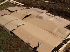 an open cardboard box laying on the ground