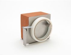 an object that looks like it is made out of cardboard and paper with a ring on the front