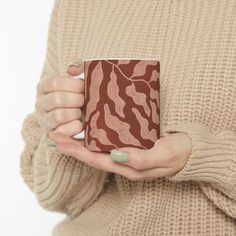 a woman holding a coffee mug in her hands