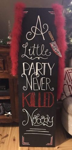 a little party never killed vodka sign in front of a christmas tree with red feathers