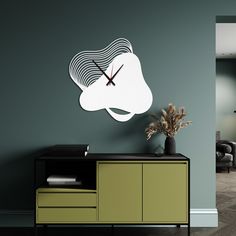 a clock that is on the side of a wall next to a cabinet with a plant in it