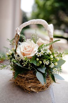 a basket filled with flowers sitting on top of a table