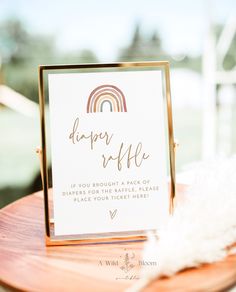 an ice cream station sign sitting on top of a wooden table next to a white feather