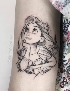 a woman's arm with a cartoon character tattoo on it