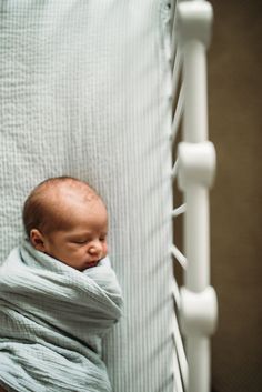 a baby wrapped in a blanket is sleeping