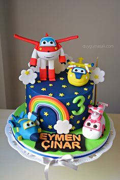 the birthday cake is decorated with fondant characters