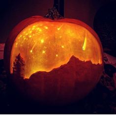 a carved pumpkin sitting on top of rocks