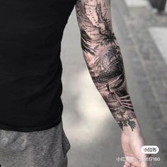 a man with a tattoo on his arm walking down the street