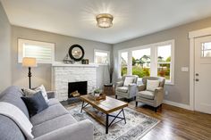 a living room filled with furniture and a fire place in the middle of a room