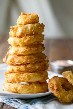 a stack of fried food sitting on top of a white plate