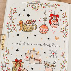 an open christmas planner with ornaments and gifts on it, next to a clipboard that says december