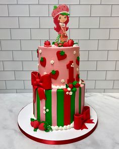 a pink and green cake with strawberries on top