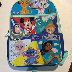 Send The Kids Back To School Or The Disney With Disney 100th Anniversary Backpack. A Keepsake For Sure! Fun Multicolor Backpack For Disney Trips, Cute Multicolor Backpack For Disney Trips, Blue Cartoon Style Backpack, Disney Multicolor Standard Backpack, Back To School Backpack For Disney Fan Events, Disney Style Multicolor Standard Backpack, Multicolor Disney Backpack, Disney Backpack For End Of School Year, Playful Backpack For Disney Trips