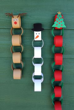 paper roll snowman and reindeer decorations hanging on the wall