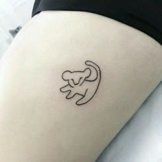 a woman's thigh with a small monkey tattoo on it