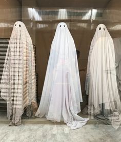 three ghost costumes are standing next to each other