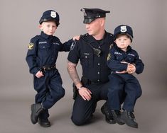 a man and two boys in police uniforms