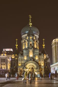 people are standing in front of an ornate building