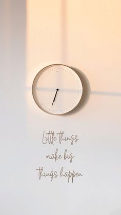 a clock with the words little things make big things happen written in cursive writing