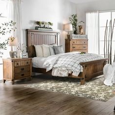 a bedroom scene with focus on the bed, dresser and nightstands that are all wood